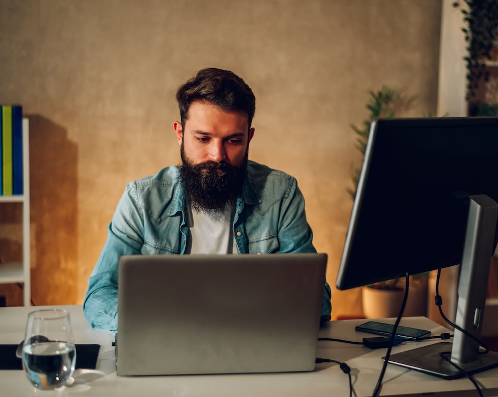 a-focused-ai-web-developer-is-sitting-at-his-home-2023-05-30-10-54-29-utc a-focused-ai-web-developer-is-sitting-at-his-home-2023-05-30-10-54-29-utc