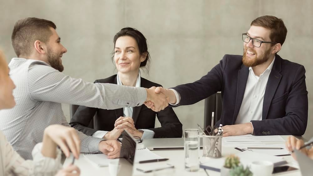 welcome-on-board-businessmen-shaking-hands-at-meet-R2PBXM6